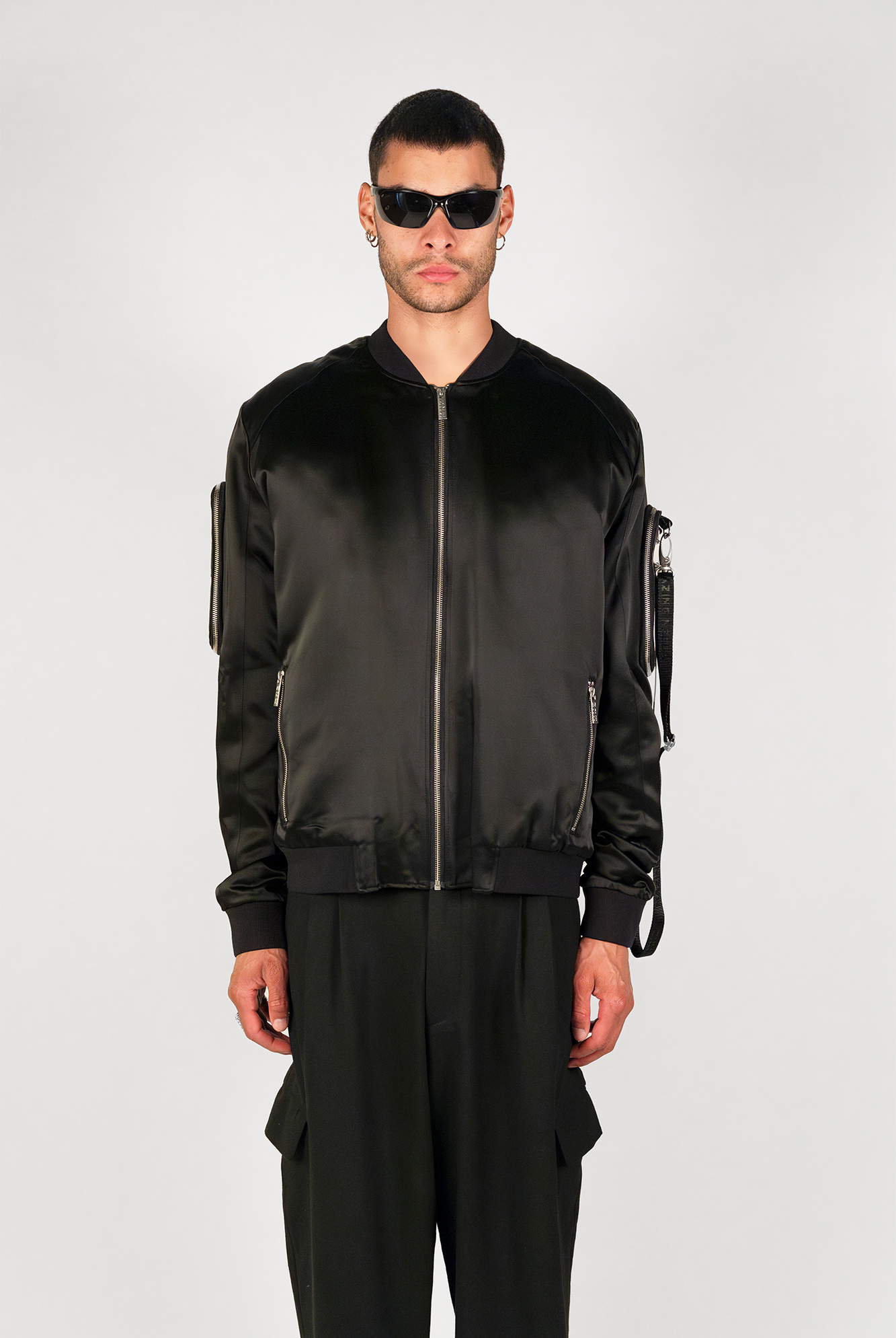 Men's bomber jacket with 3D cargo pockets, convertible crossbody bag, modular streetwear design, versatile and functional.