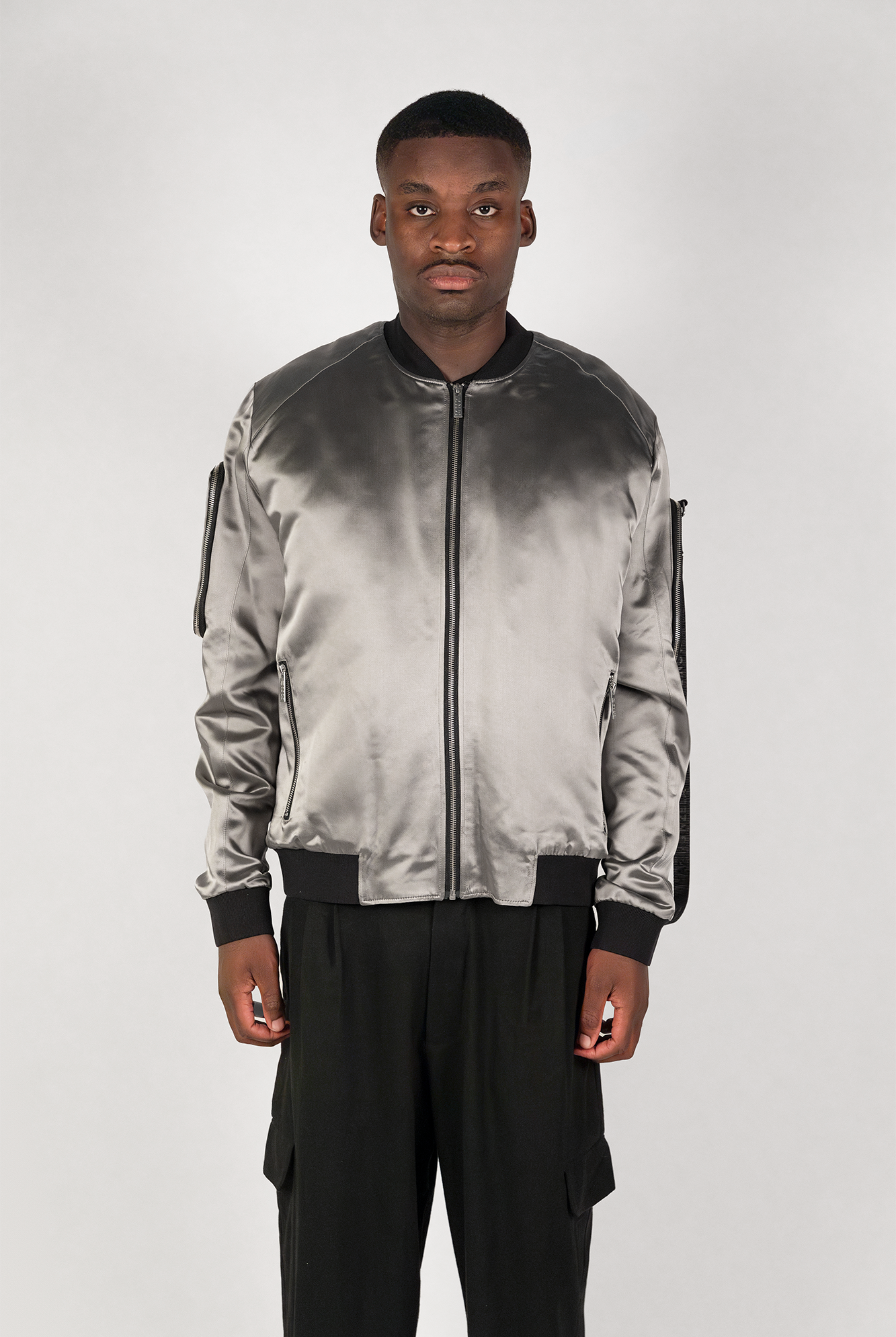 Men's bomber jacket with 3D cargo pockets, convertible crossbody bag, modular streetwear design, versatile and functional.