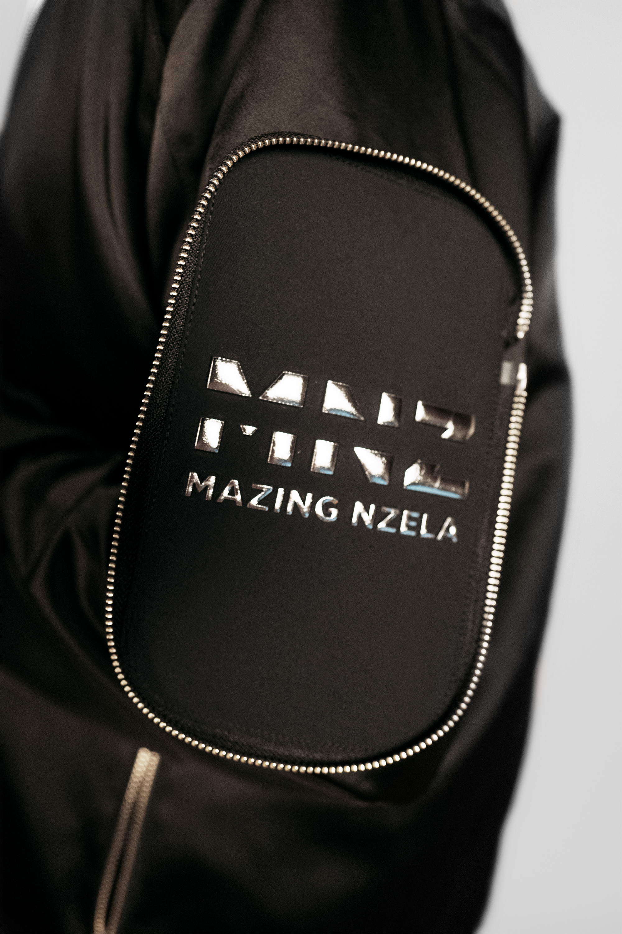 Men's bomber jacket with 3D cargo pockets, convertible crossbody bag, modular streetwear design, versatile and functional.