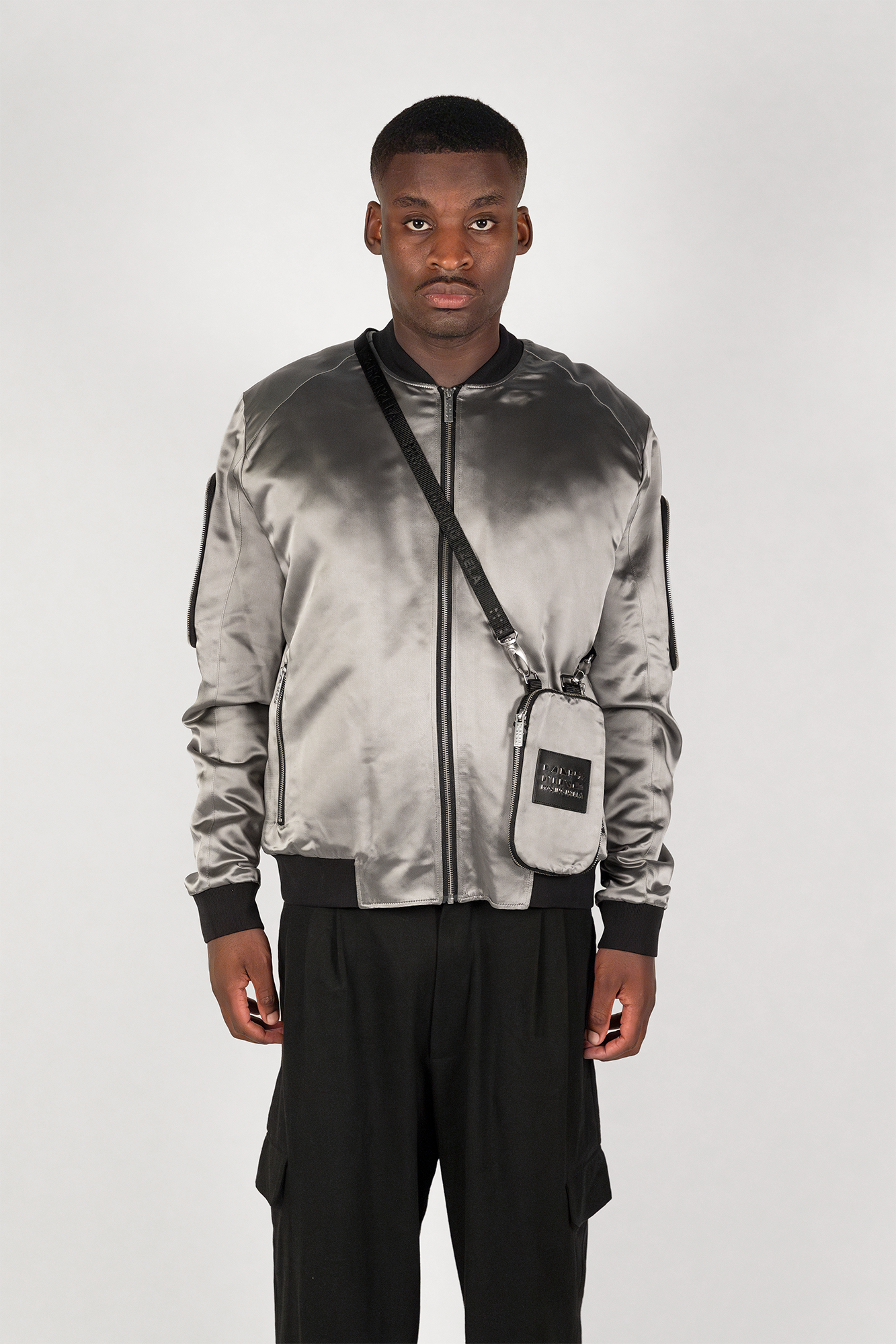Men's bomber jacket with 3D cargo pockets, convertible crossbody bag, modular streetwear design, versatile and functional.