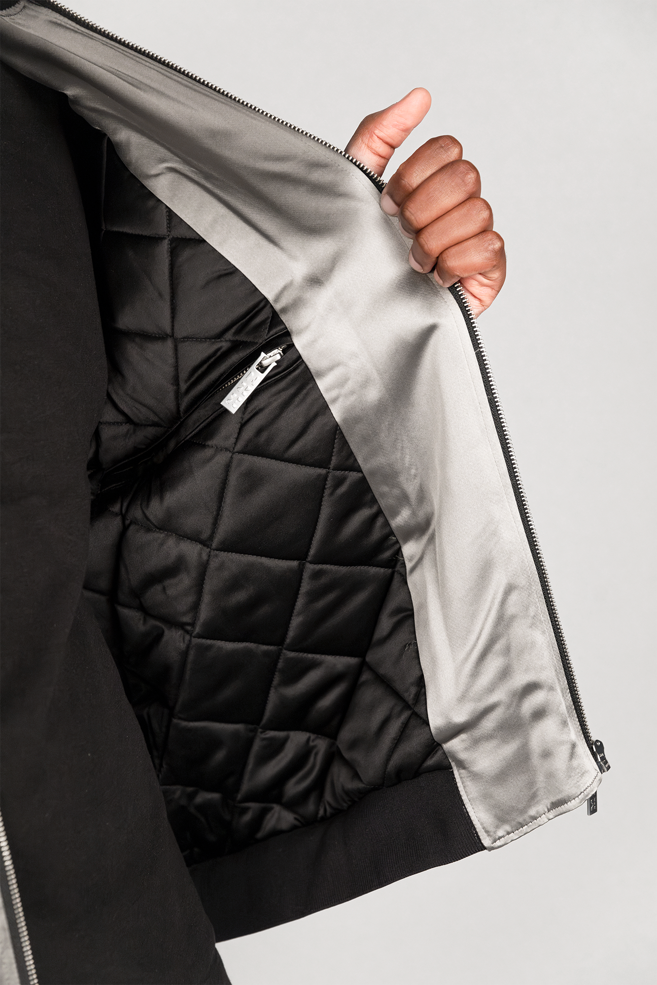 Men's bomber jacket with 3D cargo pockets, convertible crossbody bag, modular streetwear design, versatile and functional.