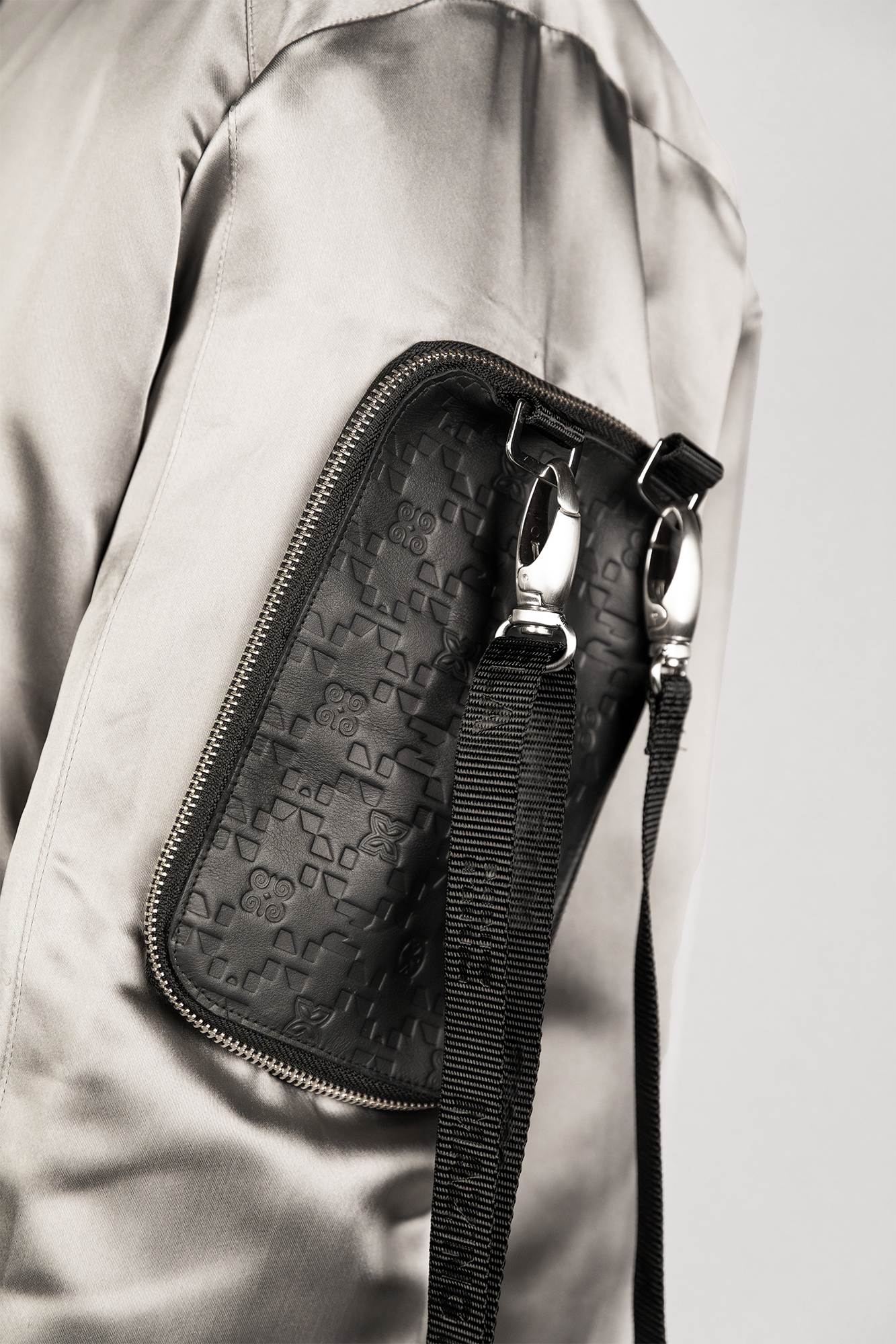 Men's bomber jacket with 3D cargo pockets, convertible crossbody bag, modular streetwear design, versatile and functional.