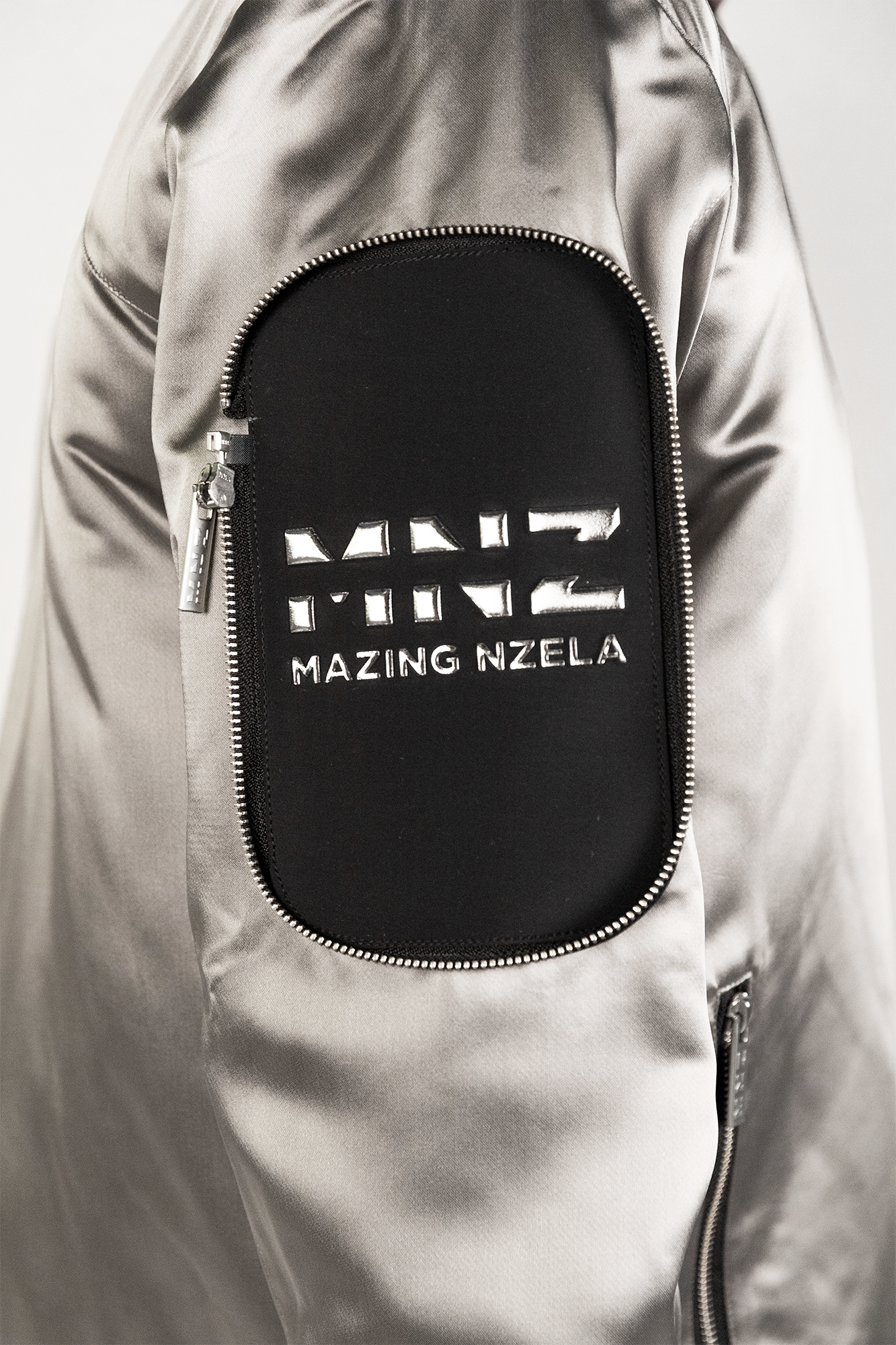 Men's bomber jacket with 3D cargo pockets, convertible crossbody bag, modular streetwear design, versatile and functional.
